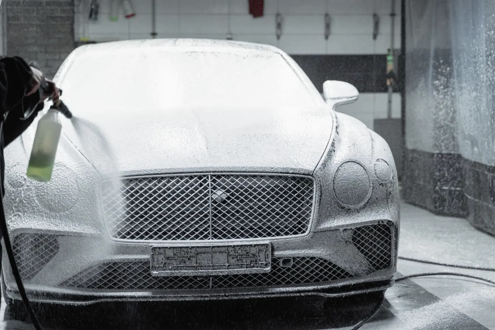 Een auto helemaal in het schuim, met de schuimlans in beeld